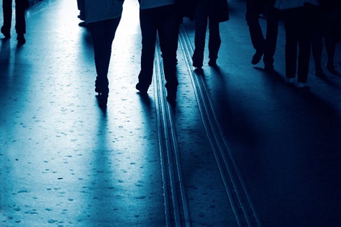 silhouettes of business people walking in hallway