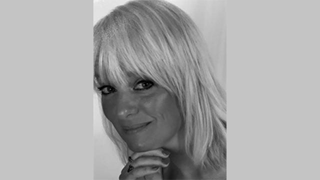 Tracy Bannon, senior principal in MITRE's Advanced Software Innovation Center, wears her hair in a short blonde shag