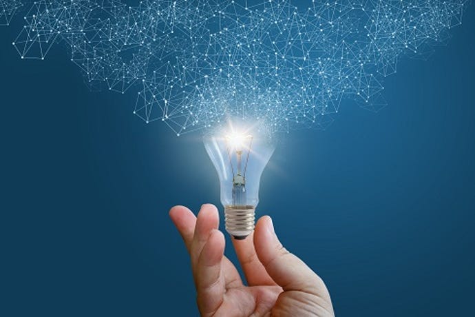 concept art of a person holding a lightbulb dissolving into geometrical constellations.