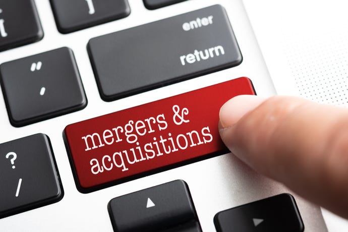Closeup of finger on computer key with the words mergers and acquisitions
