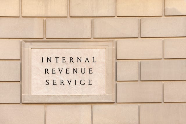 Image of the IRS logo on a brick building.