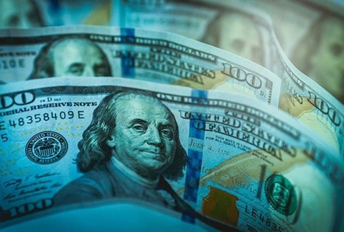 An image of multiple hundred-dollar bills