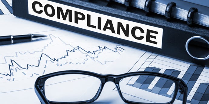 eyeglasses on a desk with a compliance sign