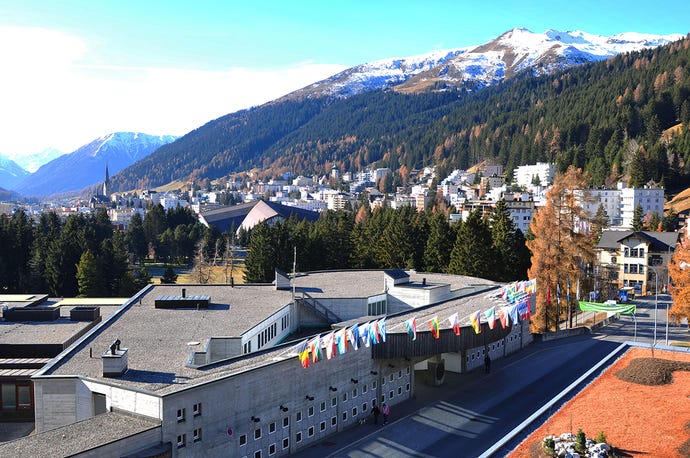 Davos-Congress-Center where the World Economic Forum WEF takes place, with snowy mountains and blue sky in background