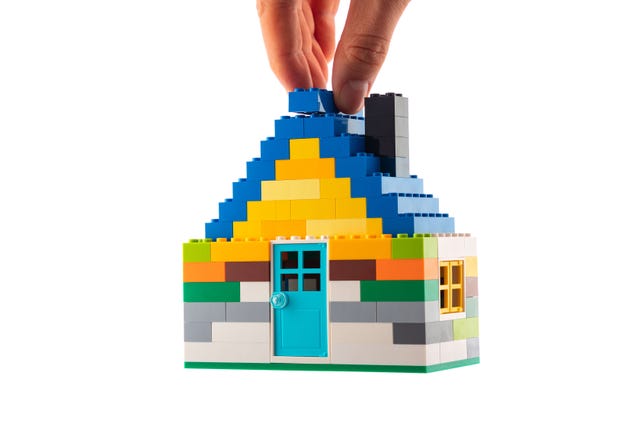 House made of classic building blocks, white studio background