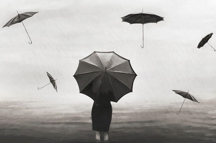 Woman standing in rain and wind storm holding an umbrella with other umbrellas floating in the wind