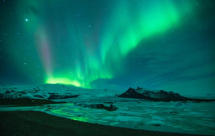 the Northern Lights (Aurora Borealis) over the Vatnajokull galcier and Fjallsarlon, eastern Iceland