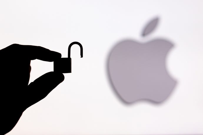 someone holding a lock in front of the Apple logo