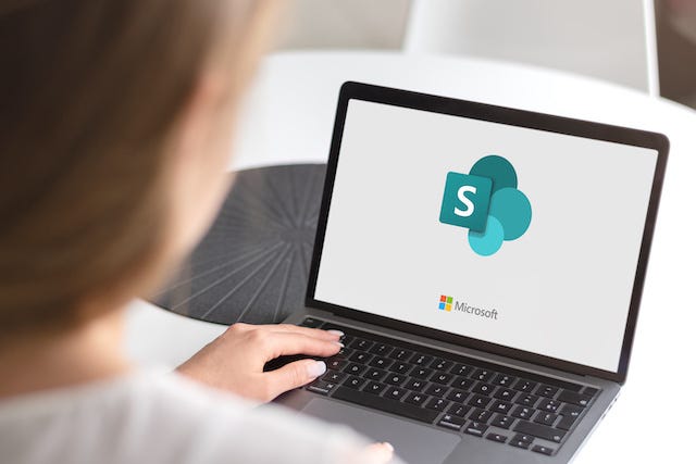 Laptop with Slack logo on the screen.