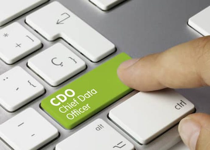 A computer keyboard with white keys has a green key that says CDO chief data officer