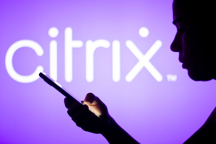 Citrix logo in the background with mobile device user in foreground