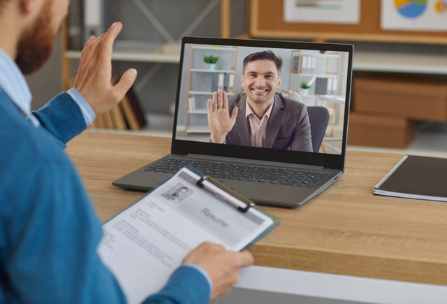 Photograph of a video interview on a laptop screen