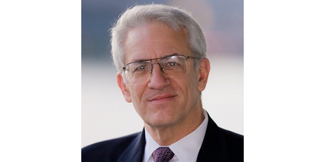 Headshot of Alan Paller, in a dark suit and tie.
