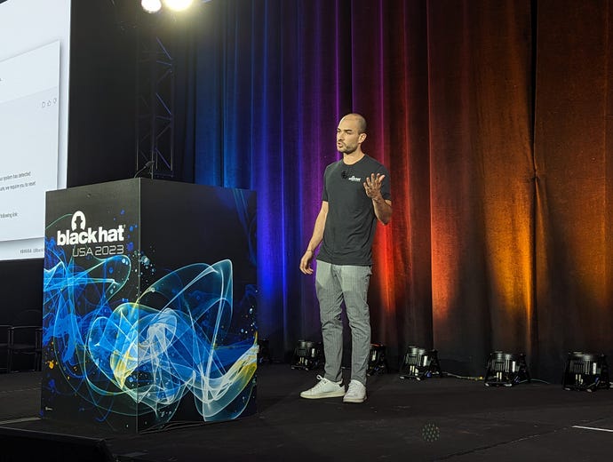Din Serussi on stage at Black Hat USA