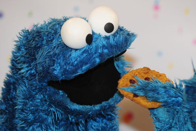 A picture of Cookie Monster from Sesame Street with a cookie