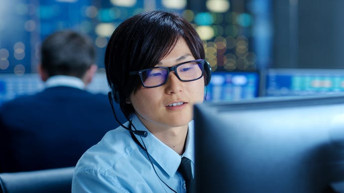 Person wearing headset in an operations center