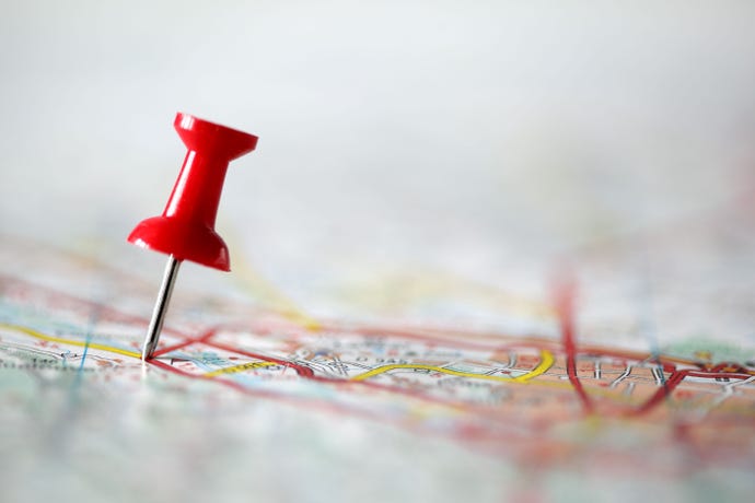 Red push pin showing the location of a destination point on a map