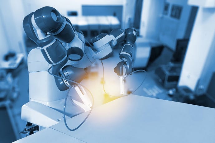 An industrial robot works on a task at a table