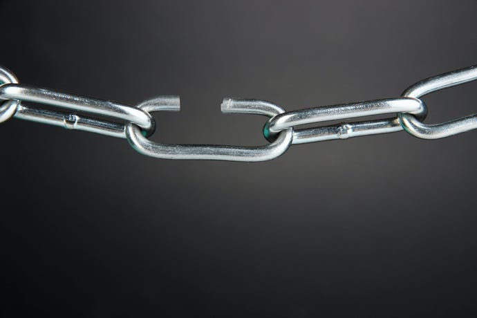broken chain link on dark background