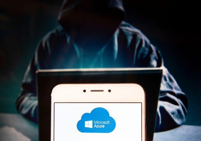 Microsoft, Azure logo on an Android mobile device with a figure of hacker in the background.