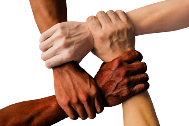 photo of diverse races linking arms