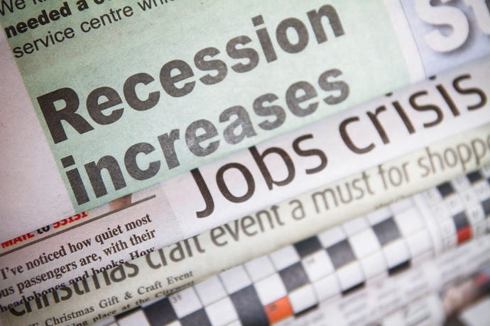 different newspapers overlapping each other with the top headline of "recession increases"