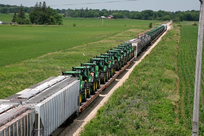 Freight train carries farm tractors from a factory in Waterloo, Iowa