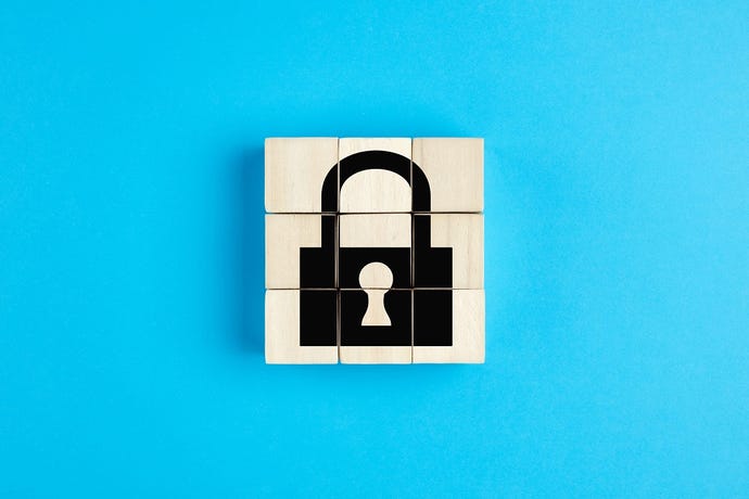 Picture of a lock on wooden blocks, with blue background