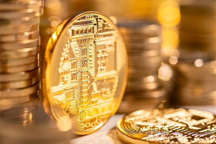 Gold coins with cryptocurrency logos on them