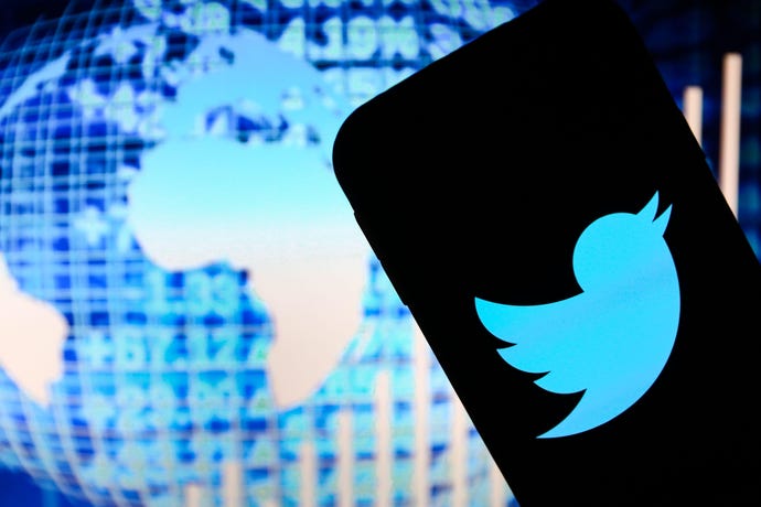 Twitter logo with digital globe in background