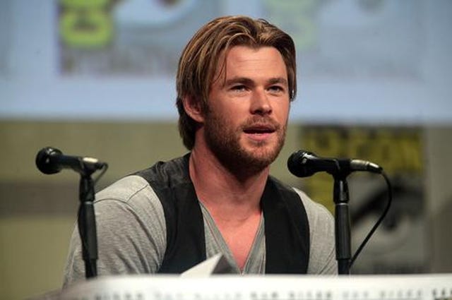 The actor Chris Hemsworth in front of a microphone