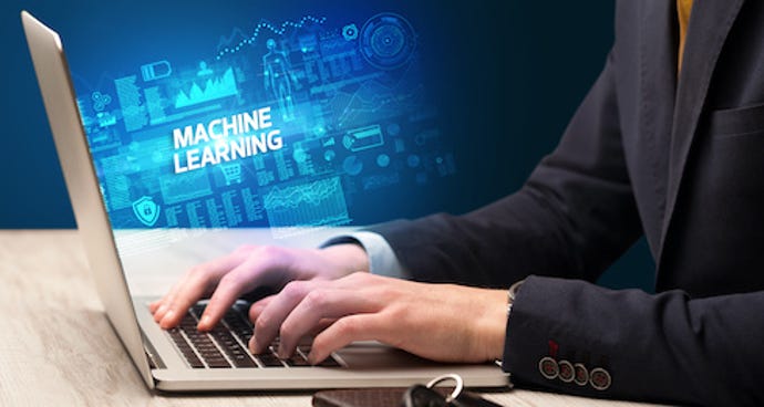hand typing on laptop with machine learning-related symbols in background.