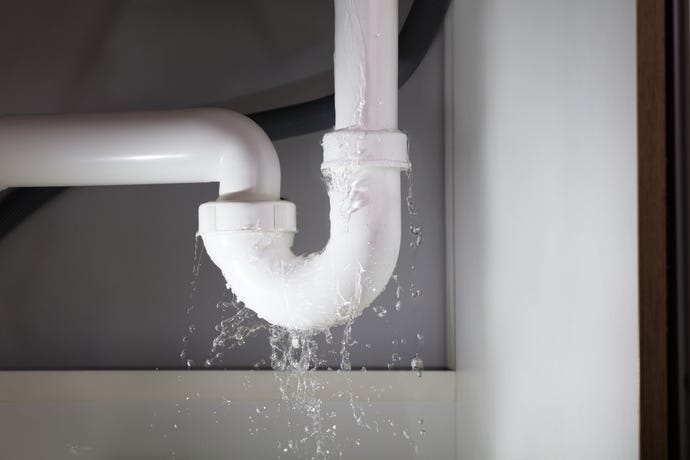 leaky PVC pipe at the u-bend in plumbing