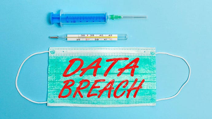Data Breach written on a surgical mask, a syringe, and a thermometer on a table to depict a security incident in healthcare.