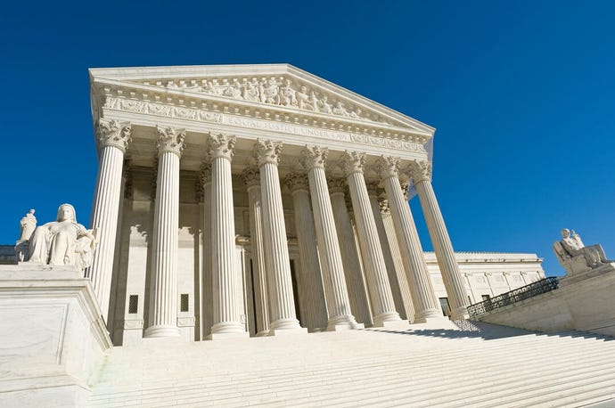 US Supreme Court building before a deep blue sky
