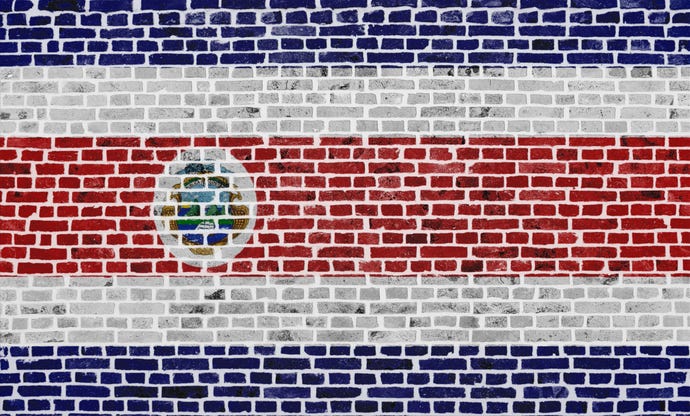 Costa Rica flag painted on brick wall