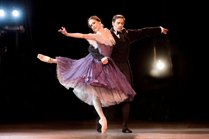 Ballerina Polina Semionova and male dancer Jason Reilly in passionate Ballet pas de deux taken from the wings