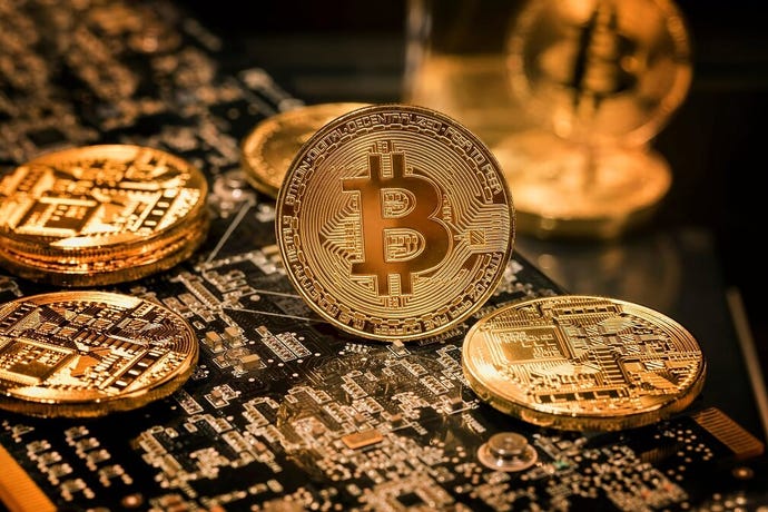 gold bitcoins with digital wiring engraved in them