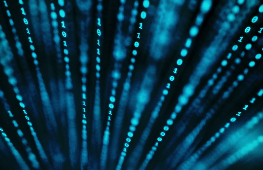 Vertical lines of binary code in 3D space with very shallow depth of field and a blue, grainy color treatment.