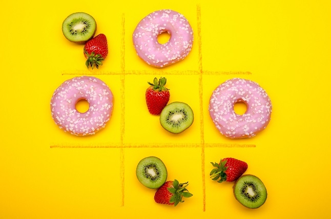 a tic tac toe board with donuts and fruits showing junk vs. substance