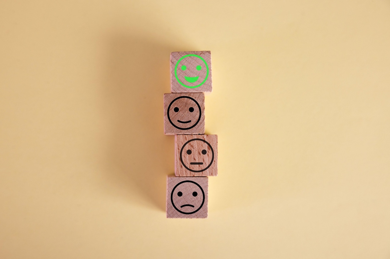 blocks with faces on them ranging from frowning to smiling blocks with faces on them ranging from frowning to smiling