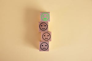 smiley face on wood block cube, customer satisfaction