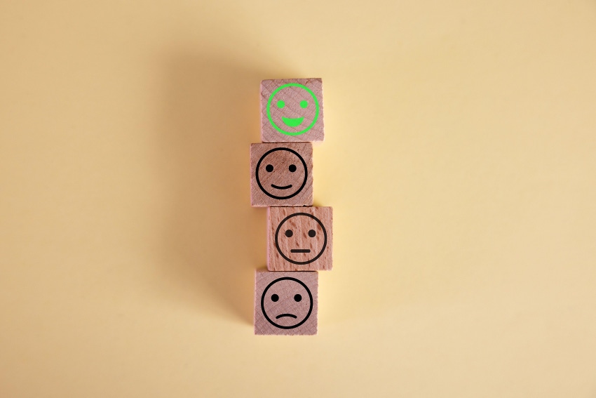 smiley face on wood block cube, customer satisfaction