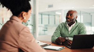 An IT executive is interviewed by an HR representative An IT executive is interviewed by an HR representative