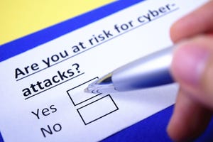 Pen filling out paper form with the question: "Are you at risk for cyberattacks?"