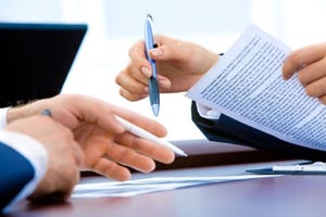 hands signing a contract
