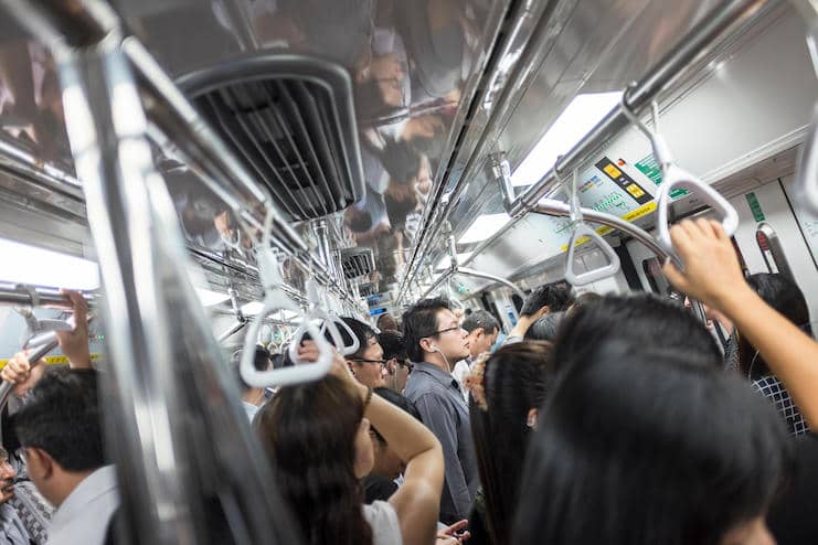 Commuters ride a crowded commuter train in Singapore
