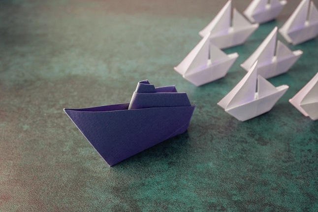 Origami paper ships, leadership concept