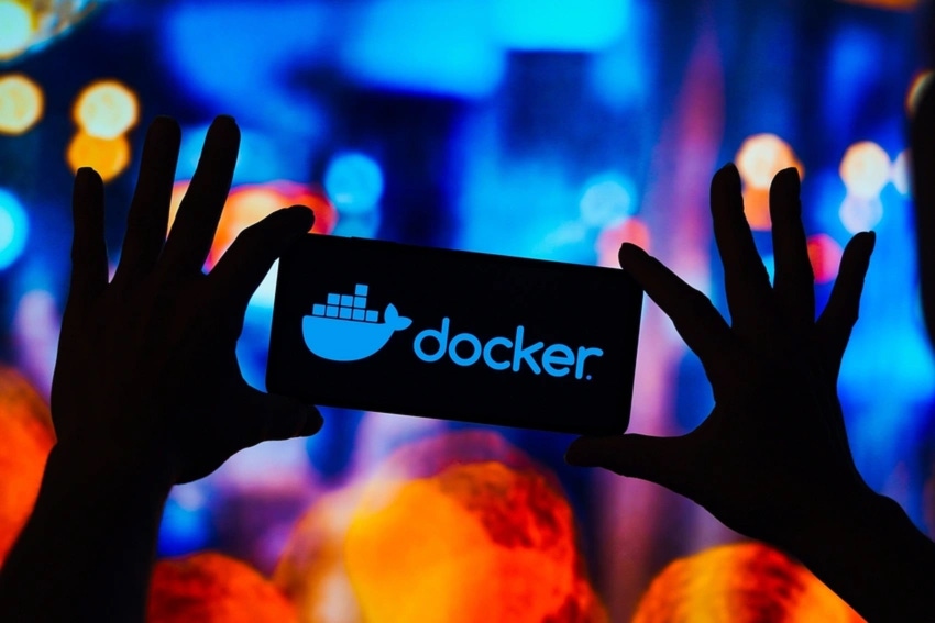 hands holding a phone with docker logo