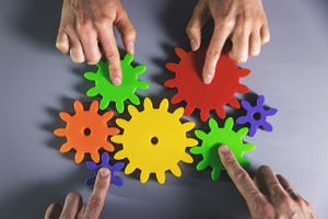business development, teamwork and collaboration concept - people connecting gears.